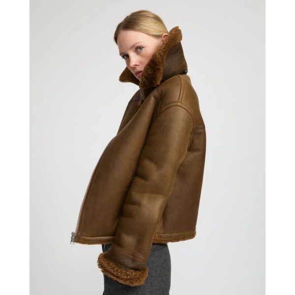 Woman wearing Yves Salomon shearling fur coat – luxury outerwear at Luxury Shoes 