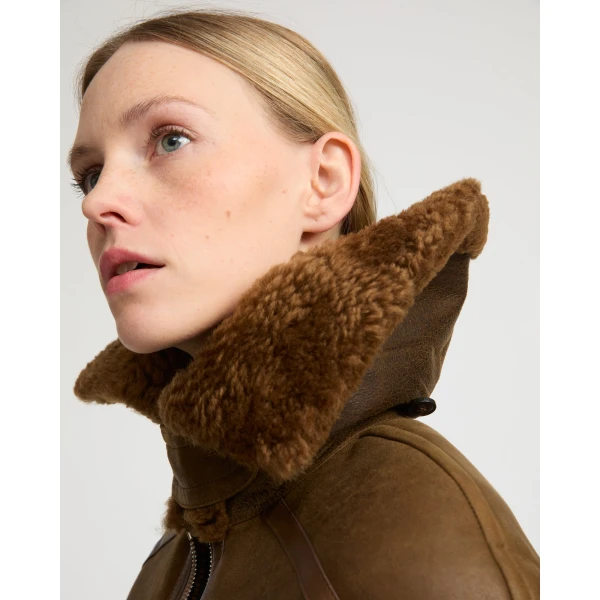 Woman wearing Yves Salomon shearling fur coat – luxury outerwear at Luxury Shoes 