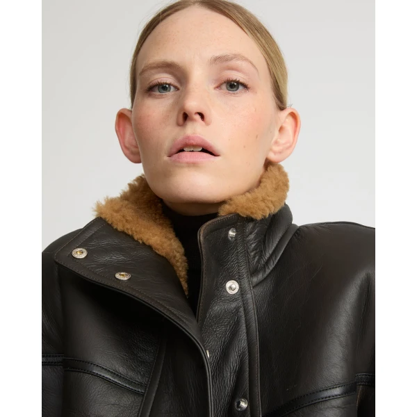 Woman wearing Yves Salomon shearling fur coat – luxury outerwear at Luxury Shoes 