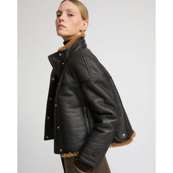 Woman wearing Yves Salomon shearling fur coat – luxury outerwear at Luxury Shoes 