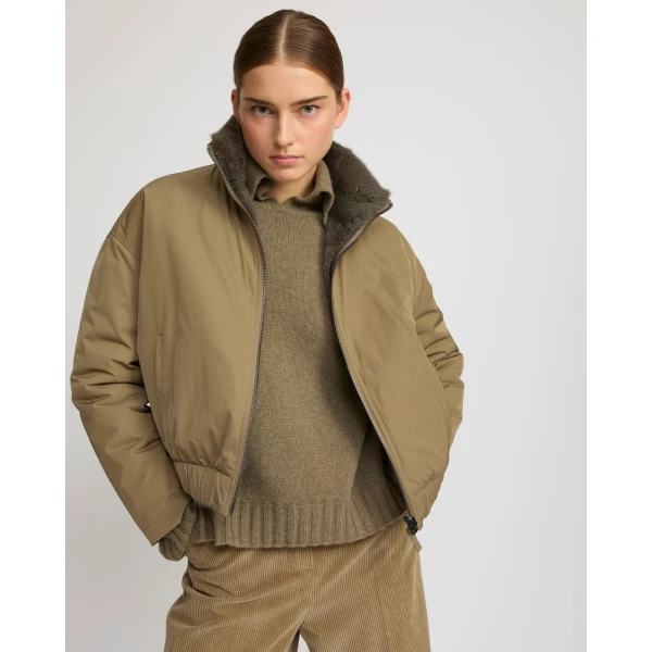 Woman wearing Yves Salomon shearling fur coat – luxury outerwear at Luxury Shoes 