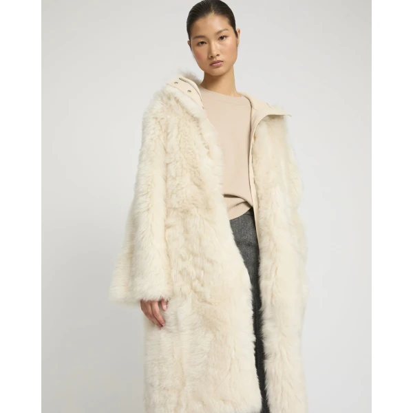 Woman wearing Yves Salomon shearling fur coat – luxury outerwear at Luxury Shoes 