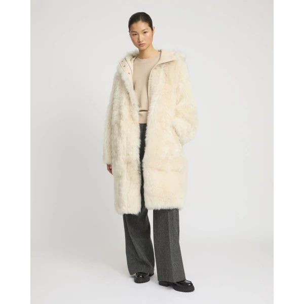 Woman wearing Yves Salomon shearling fur coat – luxury outerwear at Luxury Shoes 