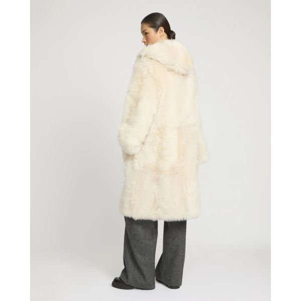 Woman wearing Yves Salomon shearling fur coat – luxury outerwear at Luxury Shoes 