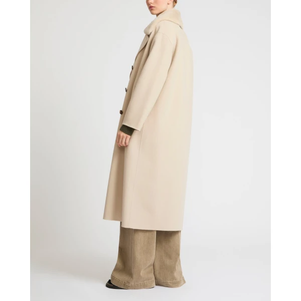 Woman wearing Yves Salomon shearling fur coat – luxury outerwear at Luxury Shoes 
