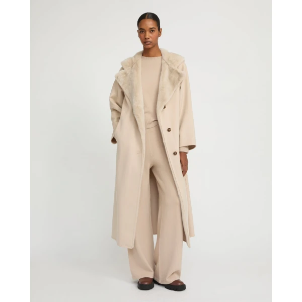 Woman wearing Yves Salomon shearling fur coat – luxury outerwear at Luxury Shoes 