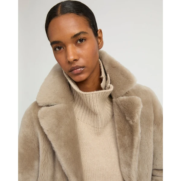 Woman wearing Yves Salomon shearling fur coat – luxury outerwear at Luxury Shoes 