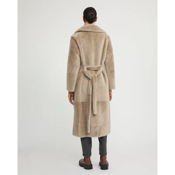 Woman wearing Yves Salomon shearling fur coat – luxury outerwear at Luxury Shoes 