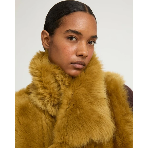 Woman wearing Yves Salomon shearling fur coat – luxury outerwear at Luxury Shoes 