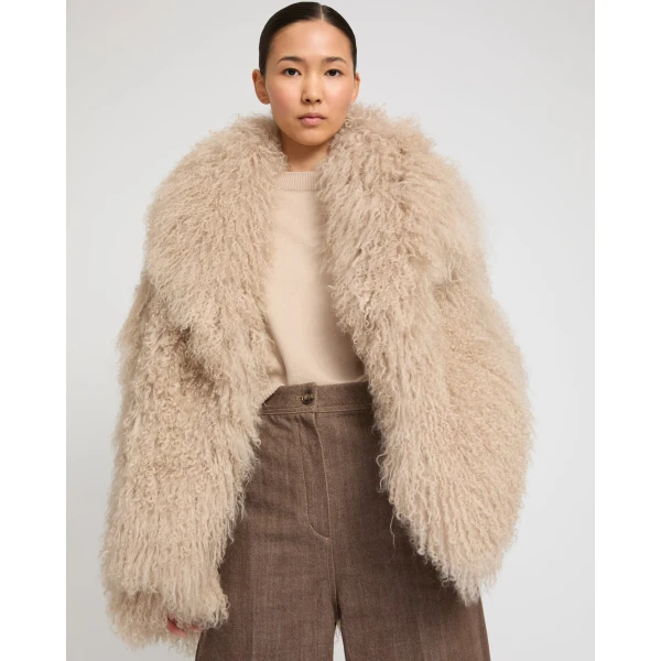 Woman wearing Yves Salomon shearling fur coat – luxury outerwear at Luxury Shoes 
