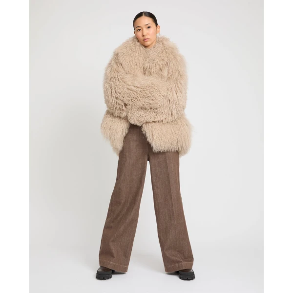 Woman wearing Yves Salomon shearling fur coat – luxury outerwear at Luxury Shoes 