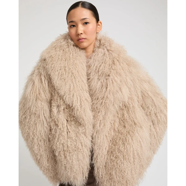 Woman wearing Yves Salomon shearling fur coat – luxury outerwear at Luxury Shoes 