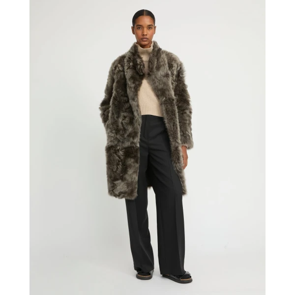 Woman wearing Yves Salomon shearling fur coat – luxury outerwear at Luxury Shoes 