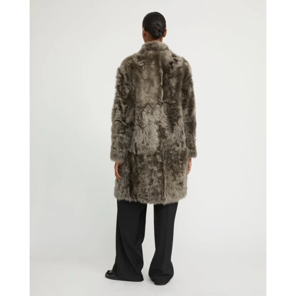 Woman wearing Yves Salomon shearling fur coat – luxury outerwear at Luxury Shoes 