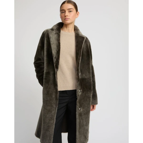 Woman wearing Yves Salomon shearling fur coat – luxury outerwear at Luxury Shoes 