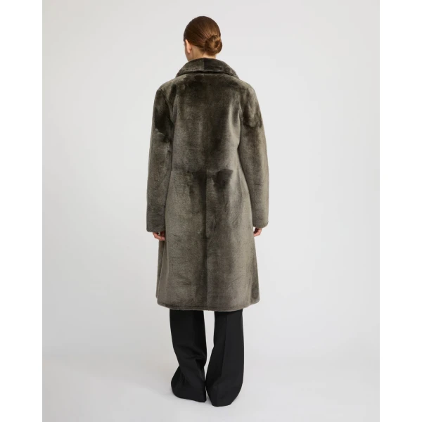 Woman wearing Yves Salomon shearling fur coat – luxury outerwear at Luxury Shoes 