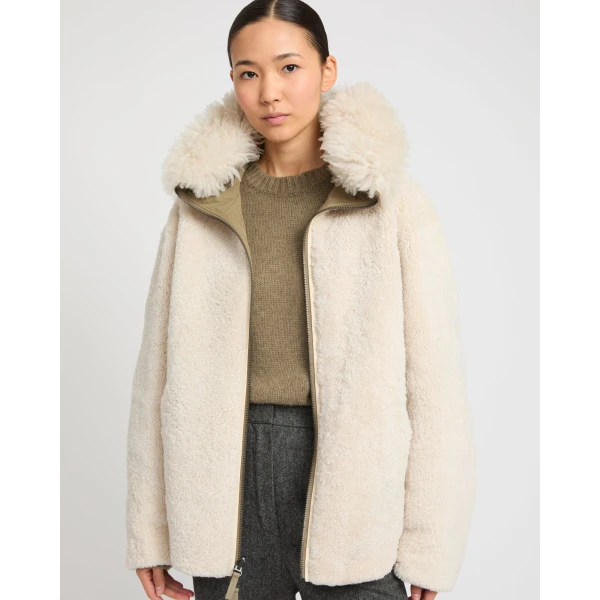 Woman wearing Yves Salomon shearling fur coat – luxury outerwear at Luxury Shoes 