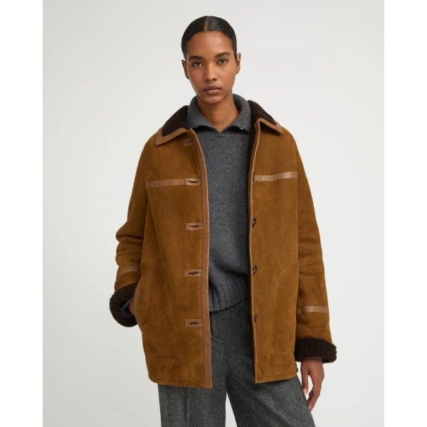 Woman wearing Yves Salomon shearling fur coat – luxury outerwear at Luxury Shoes 