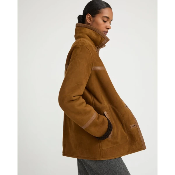 Woman wearing Yves Salomon shearling fur coat – luxury outerwear at Luxury Shoes 