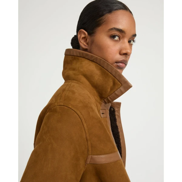 Woman wearing Yves Salomon shearling fur coat – luxury outerwear at Luxury Shoes 