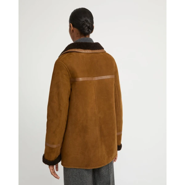Woman wearing Yves Salomon shearling fur coat – luxury outerwear at Luxury Shoes 