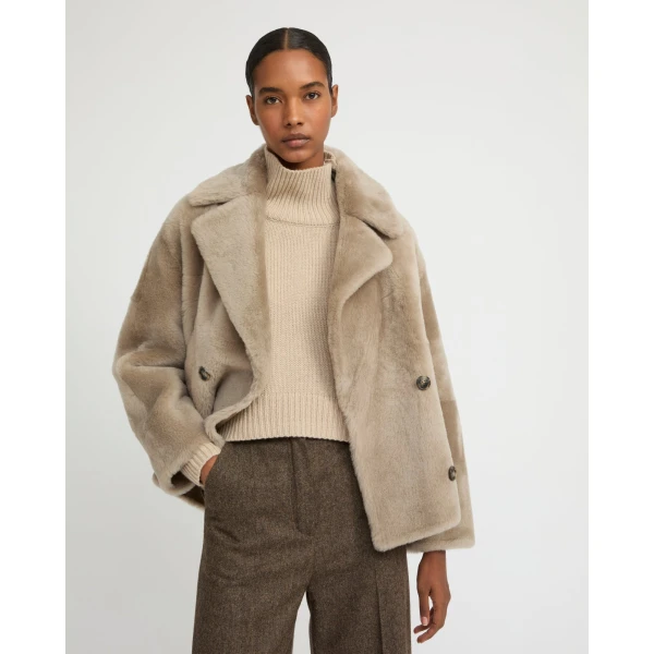 Woman wearing Yves Salomon shearling fur coat – luxury outerwear at Luxury Shoes 