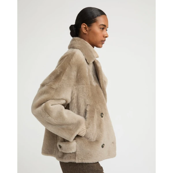 Woman wearing Yves Salomon shearling fur coat – luxury outerwear at Luxury Shoes 