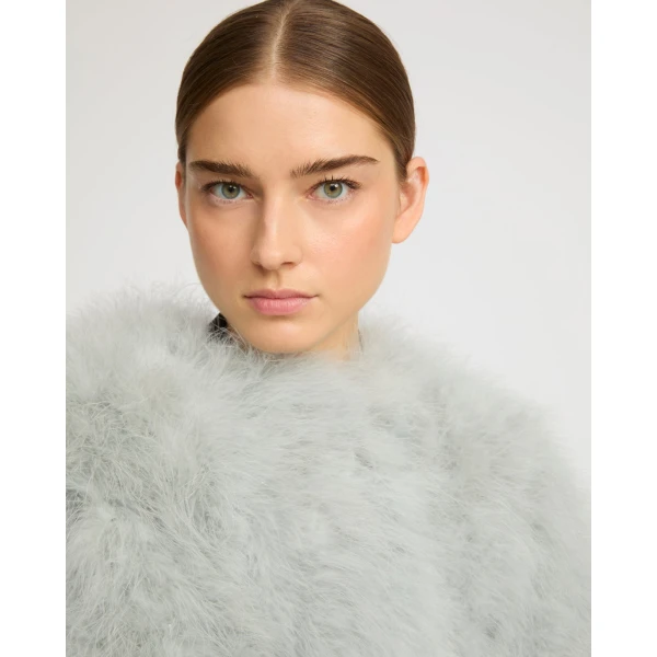 Woman wearing Yves Salomon shearling fur coat – luxury outerwear at Luxury Shoes 