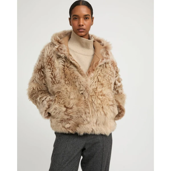 Woman wearing Yves Salomon shearling fur coat – luxury outerwear at Luxury Shoes 