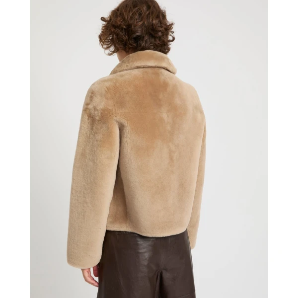 Woman wearing Yves Salomon shearling fur coat – luxury outerwear at Luxury Shoes 