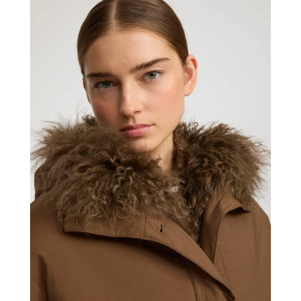 Woman wearing Yves Salomon shearling fur coat – luxury outerwear at Luxury Shoes 