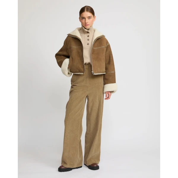 Woman wearing Yves Salomon shearling fur coat – luxury outerwear at Luxury Shoes 