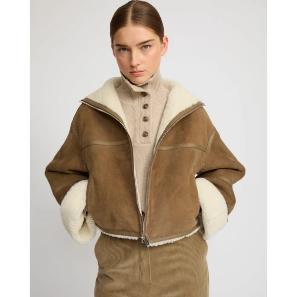 Woman wearing Yves Salomon shearling fur coat – luxury outerwear at Luxury Shoes 