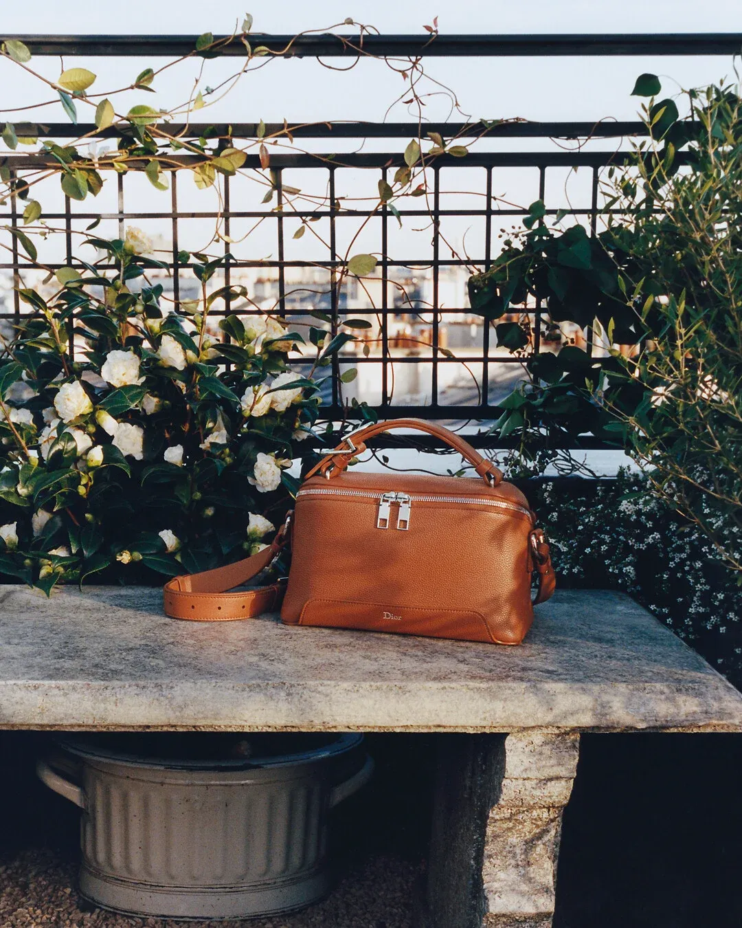 Investment wardrobe pieces — a tailored coat, cashmere knit and leather bag laid flat, for Luxury Shoes 