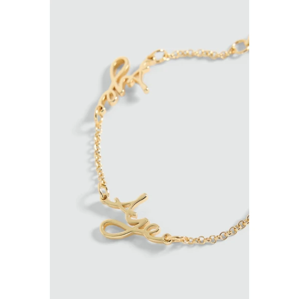 Aje Larissa Cursive Bracelet in Gold | Bracelets | Luxury Shoes 
