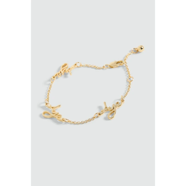 Aje Larissa Cursive Bracelet in Gold | Bracelets | Luxury Shoes 