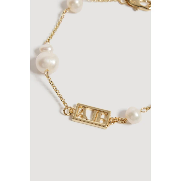 Aje Swept Logo Pearl Bracelet in Gold | Bracelets | Luxury Shoes 