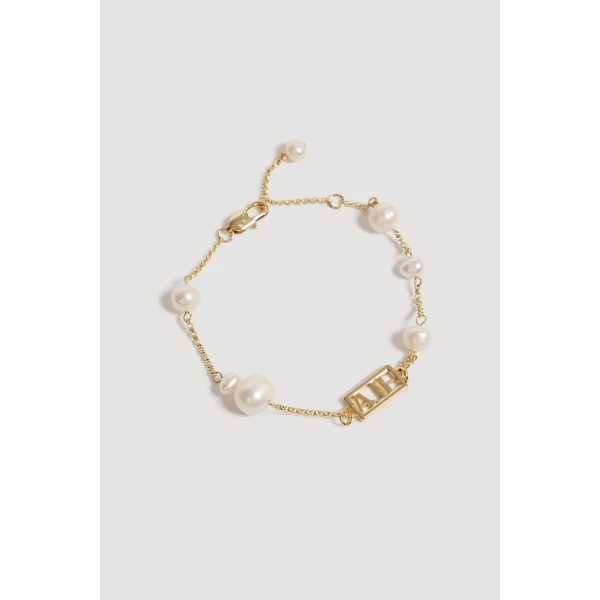 Aje Swept Logo Pearl Bracelet in Gold | Bracelets | Luxury Shoes 