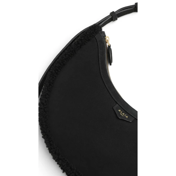 Alaia One Piece Demi Lune Bag in Merino Shearling, Black | Shoulder & Crossbody Bags | Luxury Shoes 