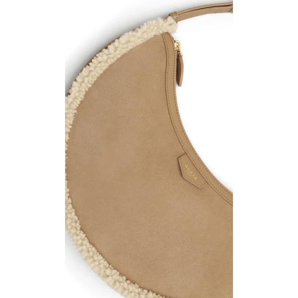 Alaia One Piece Demi Lune Bag in Merino Shearling, Camel | Shoulder & Crossbody Bags | Luxury Shoes 