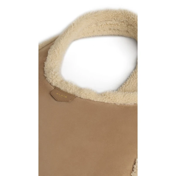 Alaia One Piece Hobo Bag in Merino Shearling, Camel | Shoulder & Crossbody Bags | Luxury Shoes 
