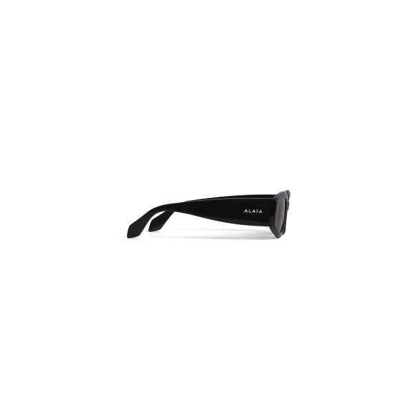 Alaia Oval Sunglasses in Black | Sunglasses | Luxury Shoes 